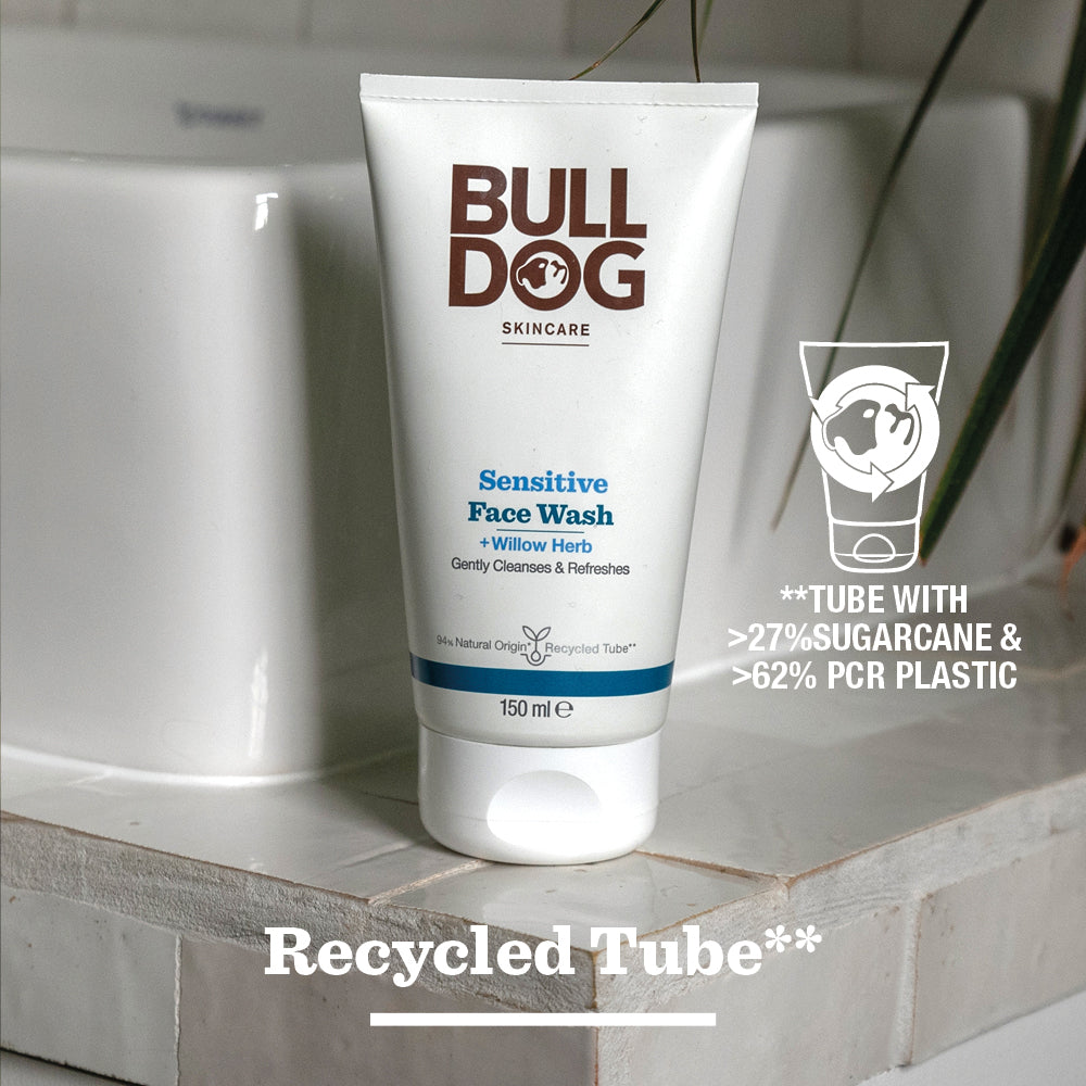 A tube of Sensitive Face Wash stands on a bathroom counter, made from over 27% sugarcane and 62% recycled plastic. This face wash for sensitive skin contains natural origin ingredients like soothing willow herb in a recycled tube.
