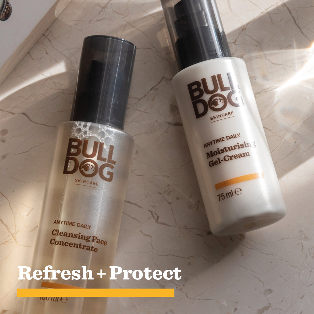 The Bulldog Skincare Anytime Daily Moisturising Gel Cream rests on a marble surface in sunlight with soft shadows. Refresh + Protect appears below, highlighting skin hydration from natural origin ingredients.