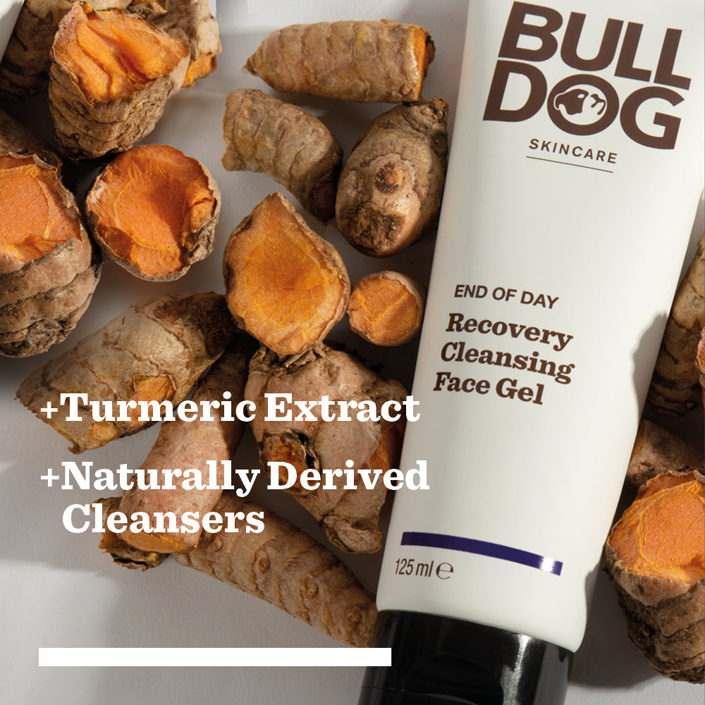 A tube of End of Day Recovery Cleansing Face Gel sits on turmeric roots, with text highlighting turmeric extract and naturally derived cleansers for a refreshing cleanse.