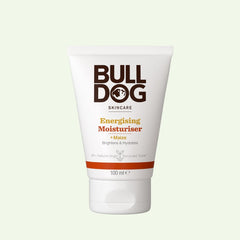 A white 100ml tube of Energising Moisturiser for men with maize, featuring brown and orange text. Designed to brighten and hydrate skin with natural origin ingredients. Shown against a light green background.