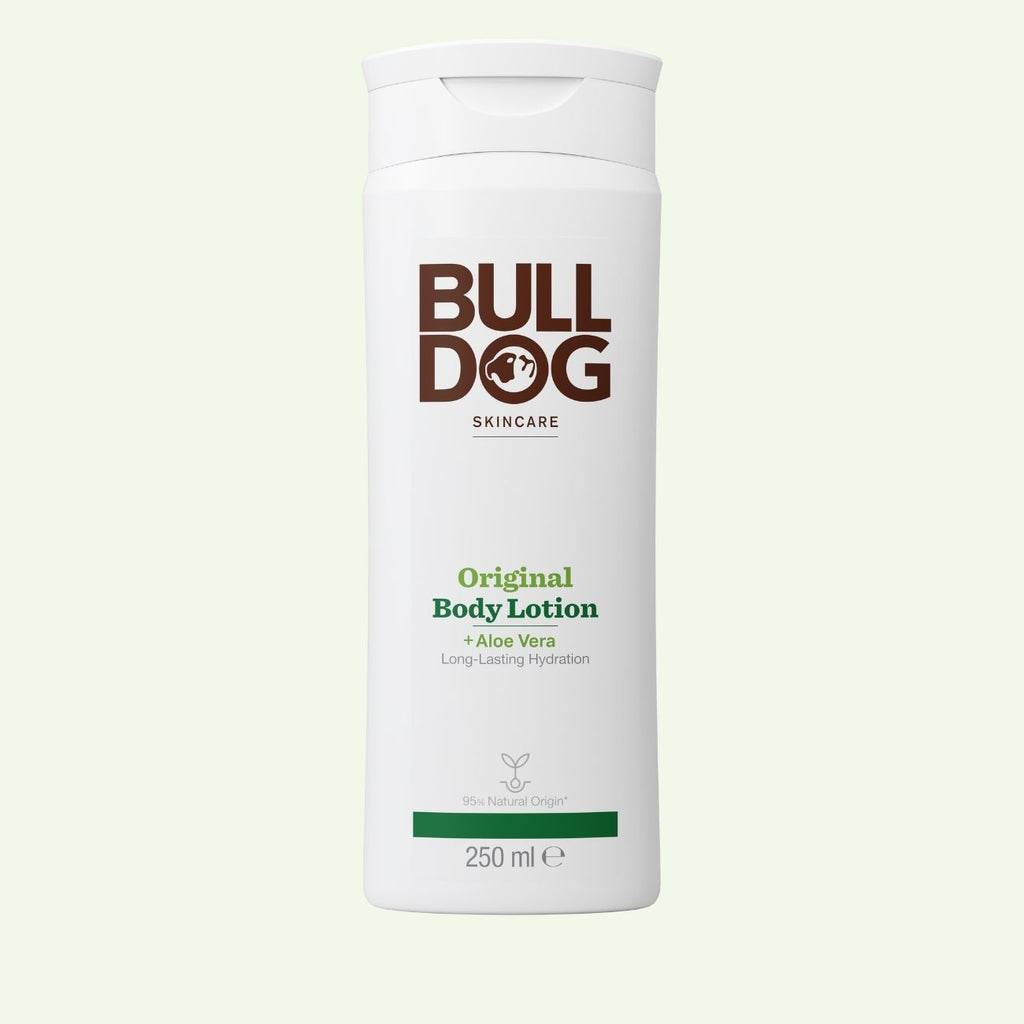 A white bottle of Bulldog Skincare’s Original Body Lotion, 250ml, with brown and green labeling, stands on a light background. Formulated with natural ingredients like Aloe Vera, it provides intense hydration for your skin.